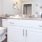 a bathroom with a large mirror a sink and a toilet