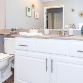 Spacious bathrooms with everything you need a bathroom with a large mirror a sink and a toilet