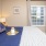 a bedroom with a bed and a table and a window