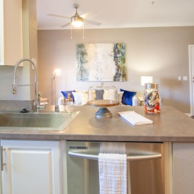 a kitchen with white cabinets a sink and a dishwasher