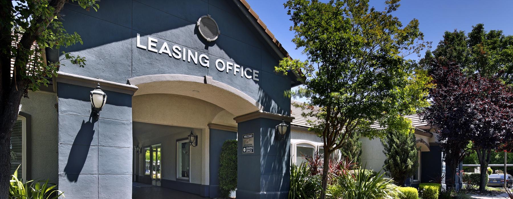 Find your perfect fit at Park Crossing front of a blue building with trees and bushes around it