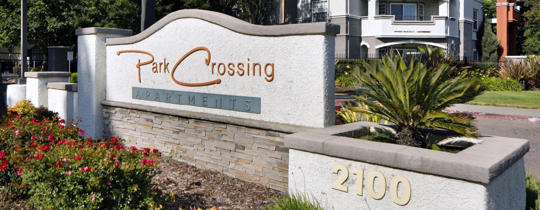 a sign on a stone wall that reads park crossing