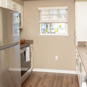Spacious kitchens with thoughtful details a kitchen with white cabinets and wood floors