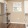 a kitchen with white cabinets and wood floors