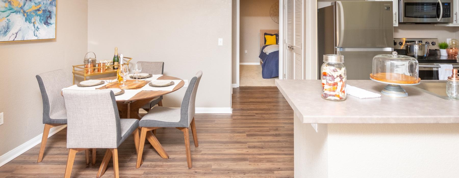Spacious kitchens with thoughtful details a kitchen with a dining table and chairs next to it