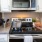 a kitchen with a stainless steel stove and a microwave